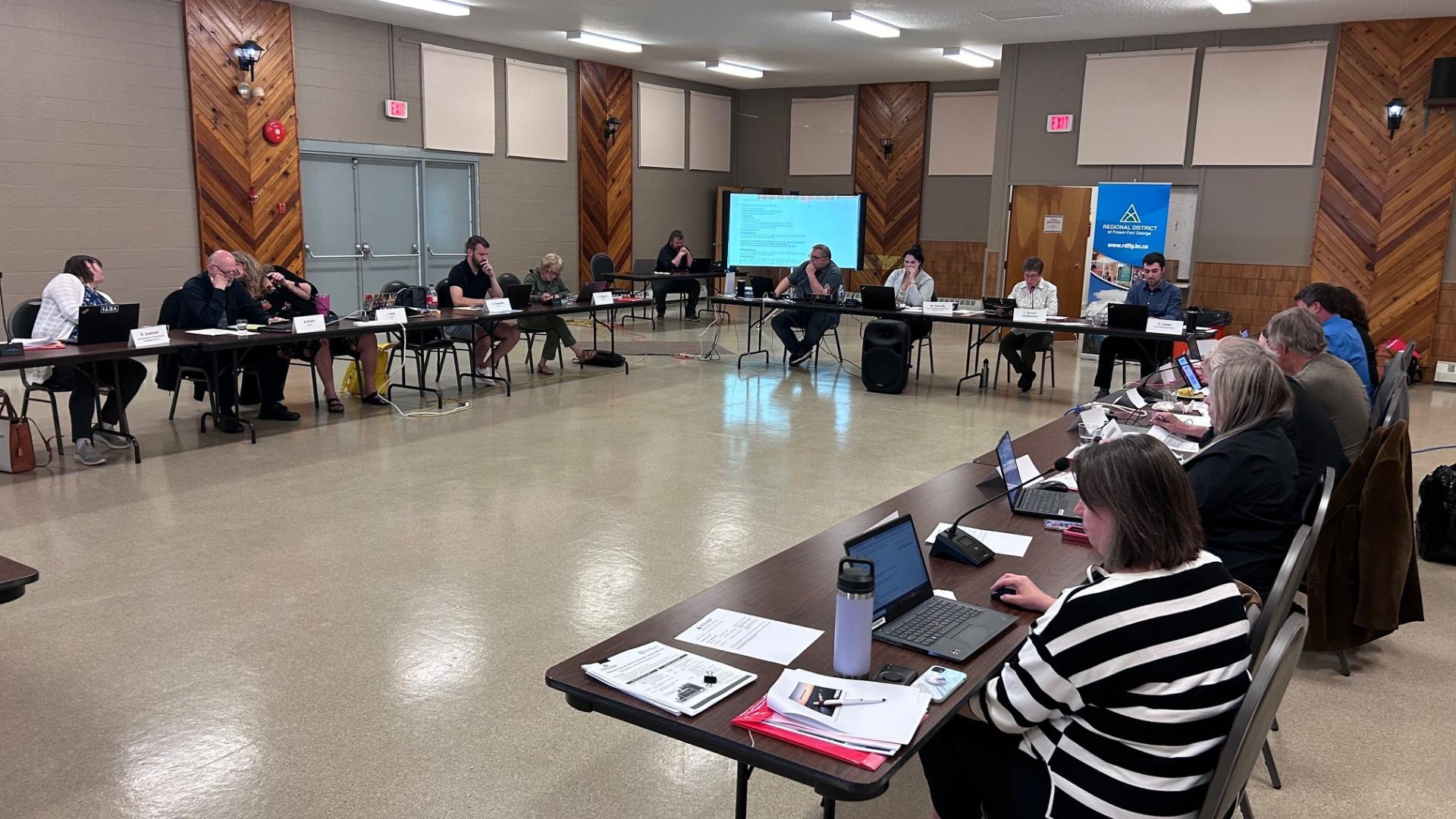 directors at tables in Valemount Community Hall