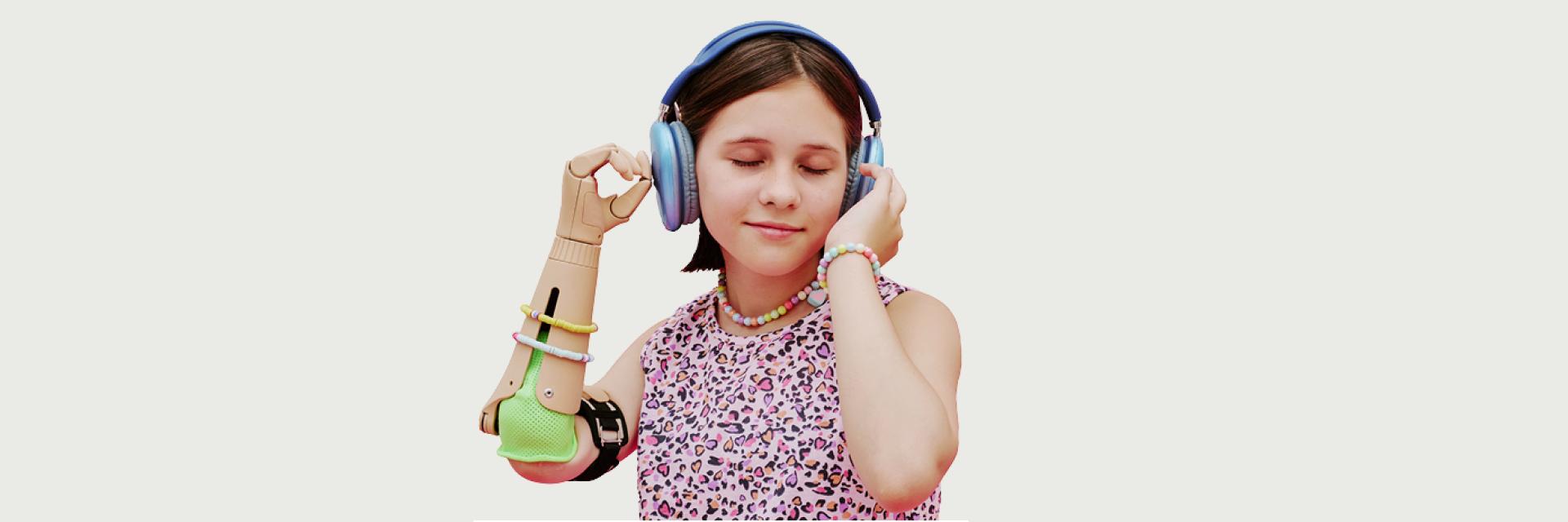 young girl with a prosthetic arm with headphones on